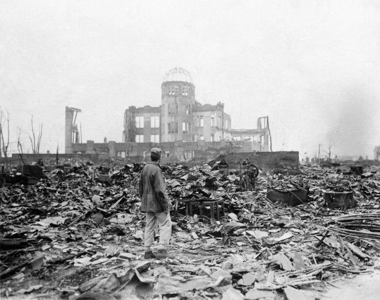 In this Sept. 8, 1945 photo, an allied correspondent stands in front of a building that once was a movie theater in Hiroshima, Japan, a month after the first atomic bomb ever used in warfare was dropped by the U.S. on Aug. 6, 1945. (AP File)