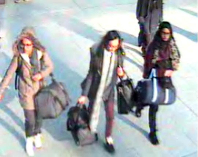 In this still taken from CCTV issued by the Metropolitan Police in London on Feb. 23, 2015, 15-year-old Amira Abase, left, Kadiza Sultana,16, center, and Shamima Begum, 15, walk through Gatwick airport, south of London, before catching their flight to Turkey on Tuesday Feb 17, 2015. (AP Photo/Metropolitan Police, File)