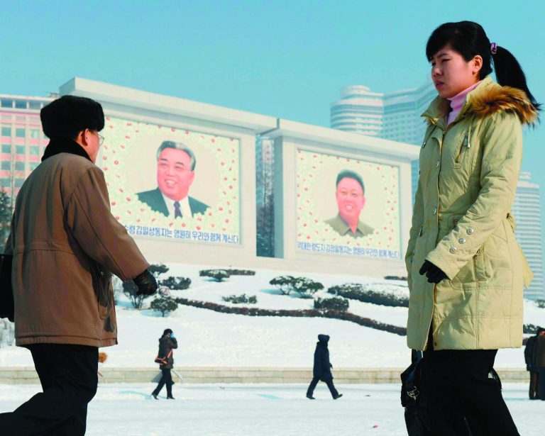 North Koreans walk by the portraits of North Korea's national founder Kim Il Sung, left, and late leader Kim Jong Il in Pyongyang, North Korea Monday, Dec. 10, 2012. North Korea on Monday extended the launch period for a controversial long-range rocket by another week until Dec. 29, citing technical problems. (AP Photo/Kyodo News) JAPAN OUT, MANDATORY CREDIT, NO LICENSING IN CHINA, FRANCE, HONG KONG, JAPAN AND SOUTH KOREA