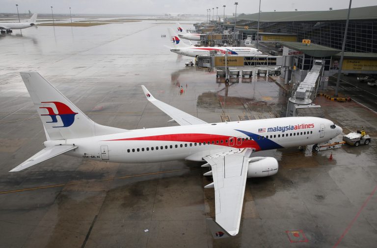 FILE - In this Aug. 8, 2014 file photo, a Malaysia Airlines Boeing 737-800 plane sits on tarmac at Kuala Lumpur International Airport in Sepang, Malaysia. Malaysia is preparing to unveil the latest overhaul of its beleaguered state-owned airline, which is reeling from twin disasters months apart that killed hundreds of passengers. Khazanah Nasional, the state investment company that owns 69 per cent of Malaysia Airlines, said in early August it will announce details of the overhaul by the end of this month. Malaysian news reports said the announcement will come Friday, Aug. 29.  (AP Photo/Vincent Thian, File)