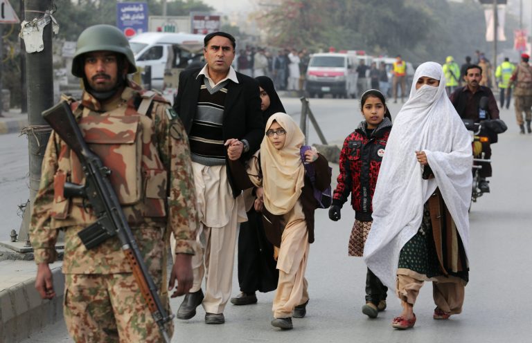 Pakistani parents escort their children outside a school attacked by the Taliban in Peshawar, Pakistan, Tuesday, Dec. 16, 2014. Taliban gunmen stormed a military-run school in the northwestern Pakistani city of Peshawar on Tuesday, killing and wounding scores, officials said, in the highest-profile militant attack to hit the troubled region in months. (AP Photo/B.K. Bangash)