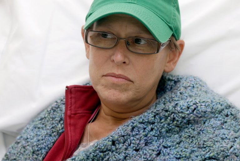   This photo taken Aug. 27, 2013 shows Bev Veals waiting for her chemotherapy treatment at Duke Cancer Center in Durham, N.C. Coping with advanced cancer, Veals was in the hospital for chemo this summer when she got a call that her health plan was shutting down. Then, the substitute coverage she was offered wanted $3,125, on top of premiums. It sounds like one of the insurance horror stories President Barack Obama used to sell his health overhaul to Congress, but Veals wasnât in the clutches of a profit-driven company. Instead, sheâs covered by Obamaâs law _ one of about 100,000 people with serious medical issues in a financially troubled government program. (AP Photo/Gerry Broome)  