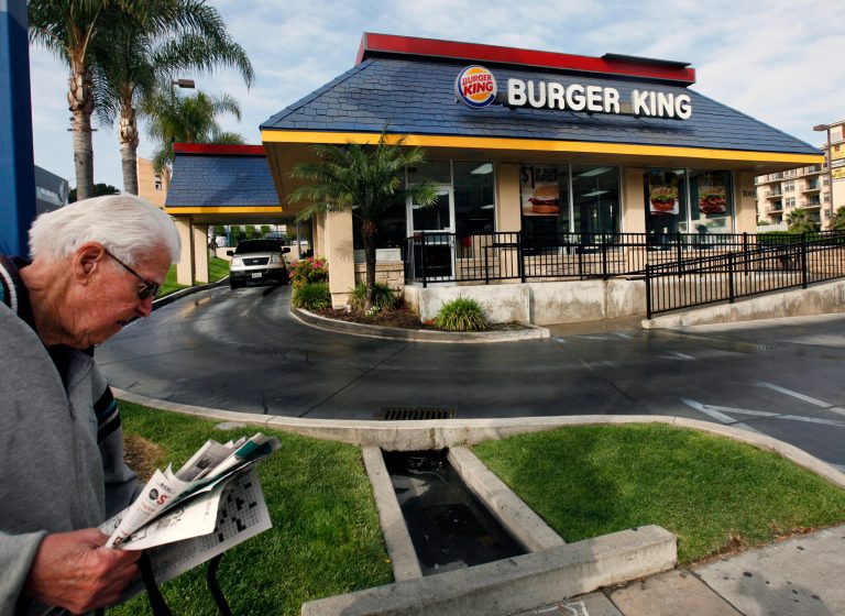 FILE - In this Thursday, April 25, 2013, file photo, a pedestrian walks past a Burger King restaurant near downtown Los Angeles. On Friday, April 25, 2014, Burger King reported a higher first-quarter profit as cost-cutting offset weak sales in the U.S. The Miami-based chain said global sales at established locations rose 2 percent, including a 0.1 percent increase in the U.S.(AP Photo/Nick Ut, File)