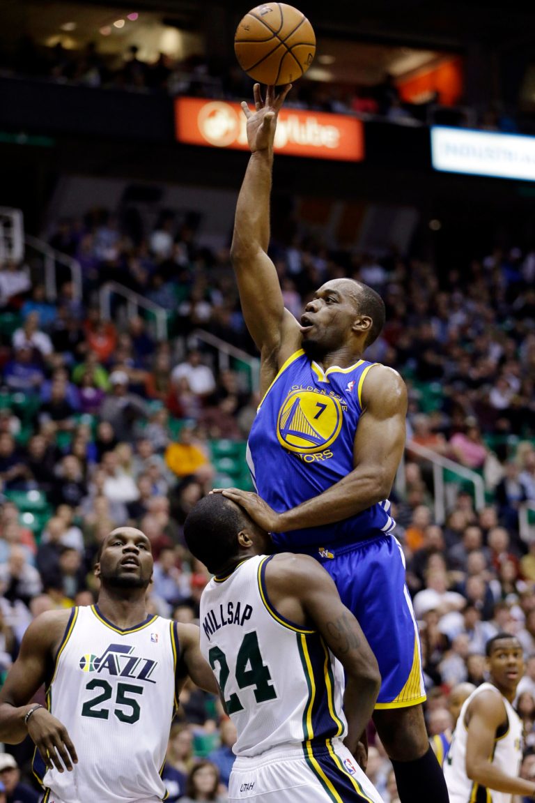   Golden State Warriors forward Carl Landry (7) fouls Utah Jazz power forward Paul Millsap as he goes to the basket in the second quarter of an NBA basketball game, Wednesday, Dec. 26, 2012, in Salt Lake City. (AP Photo/Rick Bowmer)  