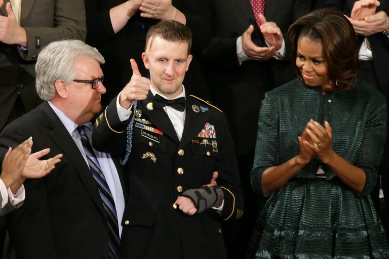 Army Ranger Sgt.1st Class Cory Remsburg acknowledges applause from first lady Michelle Obama and others during President Barack Obama's State of the Union address on Capitol Hill in Washington, Tuesday Jan. 28, 2014. (AP Photo/J. Scott Applewhite)