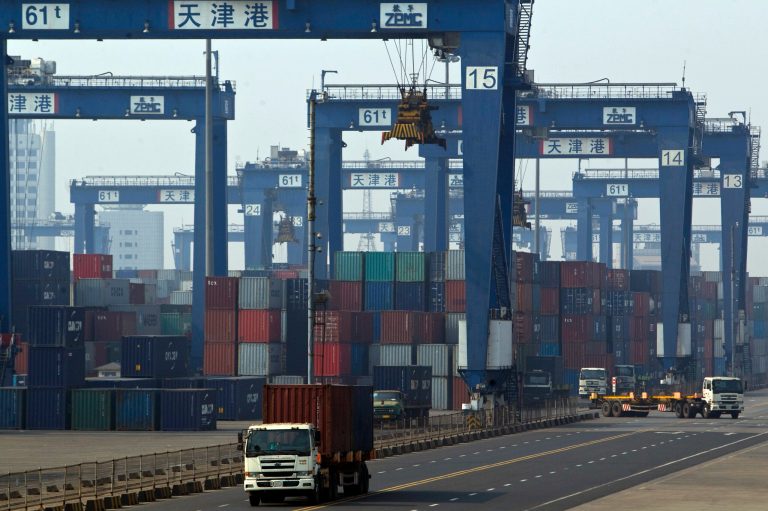   FILE - In this Tuesday, Feb. 28, 2012 photo, trucks transport containers at a port in Tianjin, China. The U.S. current account trade deficit widened in the first three months to the largest imbalance since late 2008, reflecting a big increase in imports in oil, cars and machinery and a drop in U.S. earnings on overseas investments. The Commerce Department says the deficit in the current account, the broadest measure of trade, jumped 15.7 percent to $137.3 billion, up from $118.7 billion in the final three months of last year. (AP Photo/Alexander F. Yuan, File)  