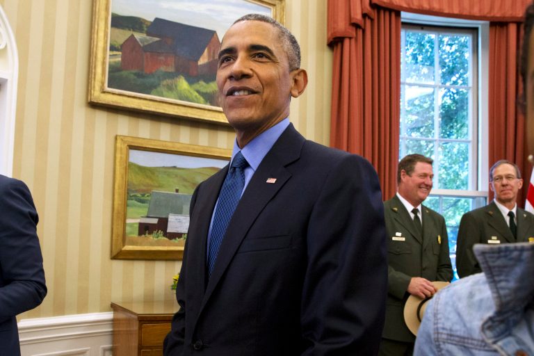 President Obama walks away from his desk after signing a designation of three new national monuments; Berryessa Snow Mountain in California, Waco Mammoth in Texas, and the Basin and Range in Nevada, in the Oval Office of the White House Friday, July 10, 2015, in Washington. (AP Photo/Jacquelyn Martin)