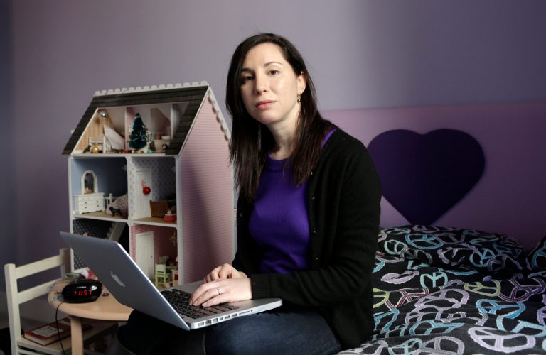 In this March 4, 2013 photo, Rebecca Levey, mother of 10-year-old twin girls, poses for a photograph in the girls' bedroom in New York. Levey, who also runs a tween video review site called KidzVuz.com and blogs about technology and educations issues, says, ?What sex education used to be_ it's now the 'technology talk' we have to have with our kids.? She explains that children need to understand the pitfalls of carelessly sharing personal information online. (AP Photo/Kathy Willens)