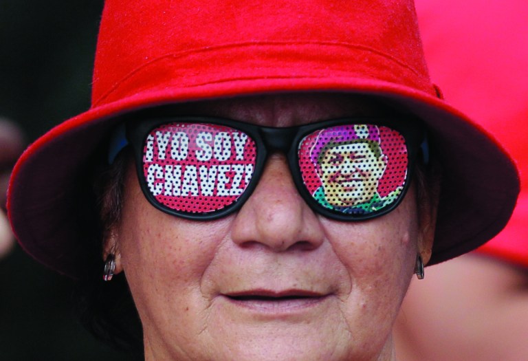 A supporter of Venezuela's President Hugo Chavez wears glasses that reads in Spanish 
