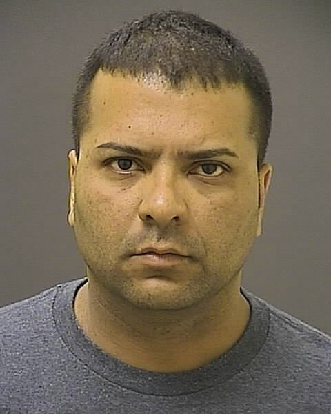 This handout photo provided by the Baltimore Police Department shows Officer Gualberto Diaz. Baltimore Police say Diaz who was on duty and in uniform kicked and punched his wife and pointed his service weapon at her and her boyfriend at the boyfriend's home.  (AP Photo/Baltimore Police Department)