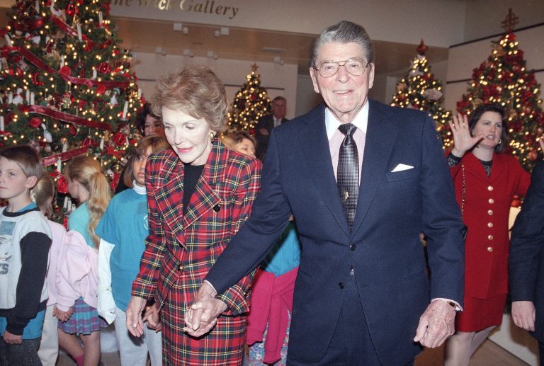 Former President Ronald Reagan and his wife Nancy Reagan tour the 