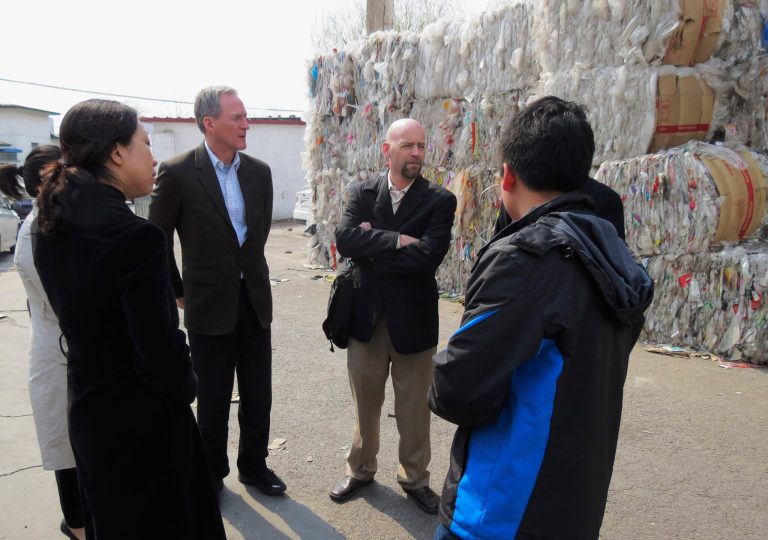 FILE - In this April 7, 2013 file photo provided by Gov. Dennis Daugaard's office, South Dakota Gov. Dennis Daugaard, center left, and Jake Anderson, right, owner and president of Millennium Recycling in Sioux Falls, speaks with Chinese officials at a recycling center in Beijing. Daugaard will be joined by representatives from 11 companies and groups from around South Dakota when he makes his third trade mission to China May 9-16, 2014. (AP Photo/Gov. Dennis Daugaard's Office, Kelsey Webb, File)