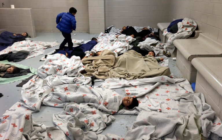 In this June 18, 2014, file photo, detainees sleep in a holding cell at a U.S. Customs and Border Protection processing facility in Brownsville,Texas. (AP Photo/Eric Gay, Pool)