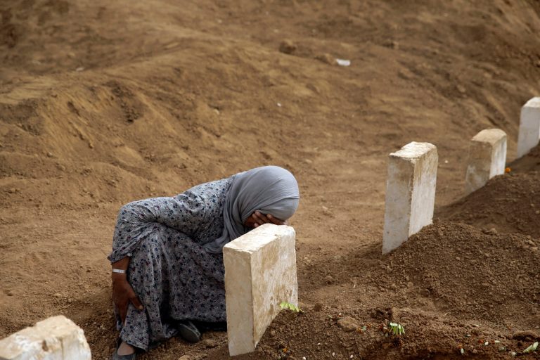 Rabia Ali mourns at the grave of her son Seydo Mehmud 'Curo', a Kurdish fighter who was killed in fighting with militants of the Islamic State group in Kobani, Syria, and was buried on Tuesday, Oct. 7, at a cemetery in Suruc, on the Turkey-Syria border, Saturday, Oct. 11, 2014. (AP Photo/Lefteris Pitarakis)