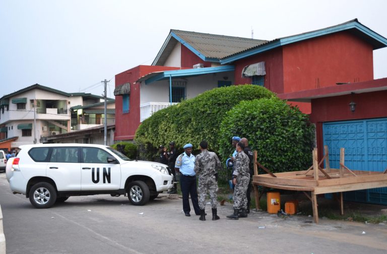 In this Saturday, Jan. 25, 2014 photo, United Nations and Ivorian police stand guard outside the ransacked headquarters of Ivory Coast's most prominent gay rights organization in Abidjan, Ivory Coast. The attack on the office, which took place Saturday afternoon but wasn't publicized until Monday, underscores the dangers confronting such groups even in the few African countries where homosexual acts are not crimes. The violence followed days of anti-gay protests in the west African country, which is sometimes considered a safe haven for homosexuals fleeing persecution elsewhere across the continent. (AP Photo)