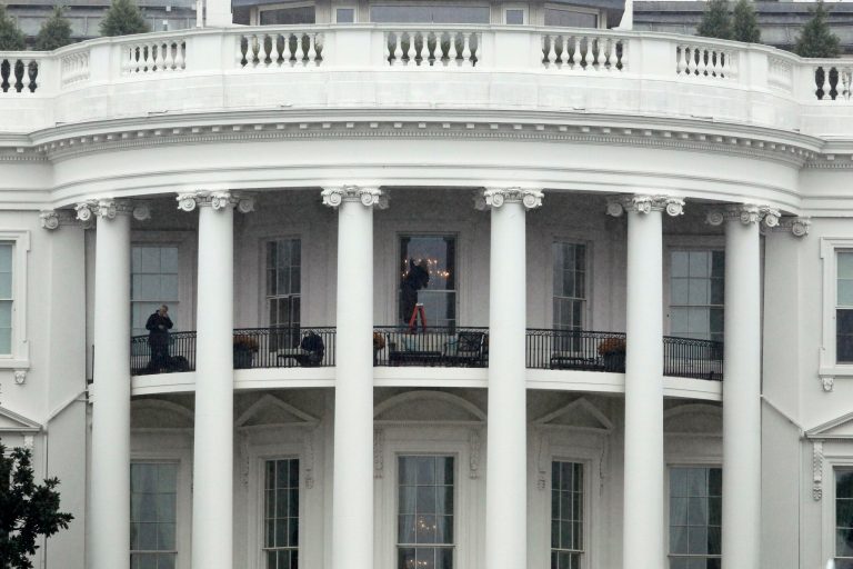 Law enforcement officers photograph a window at the White House in Washington, Wednesday, Nov. 16, 2011, as seen from the South Lawn. A bullet hit an exterior window of the White House and was stopped by ballistic glass, the Secret Service said. An additional round of ammunition was found on the White House exterior. The bullets were found Tuesday morning.