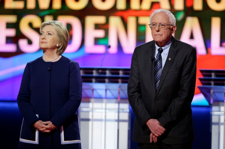 Hillary Clinton, left, and Bernie Sanders, spent started off the debate with 20 minutes of answering questions about the lead water crisis in Flint, Mich. (AP Photo/Charlie Neibergall)