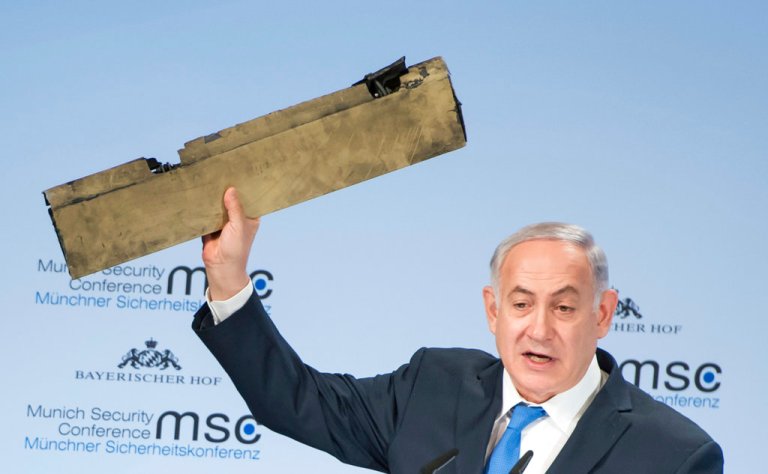 In this photo released by Lennart Preiss/MSC 2018, Israeli Prime Minister Benjamin Netanyahu, holds a part of a downed drone during his speech at the Munich Security Conference, MSC, in Munich , Germany, Sunday, Feb. 18, 2018. (Lennart Preiss/MSC 2018/dpa via AP)