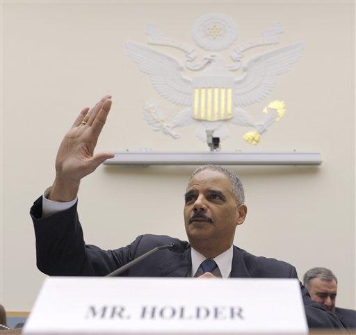 Attorney General Eric holder gestures on Capitol Hill in Washington, Thursday, Dec. 8, 2011, prior to testifying before the House Judiciary Committee hearing on Operation Fast and Furious. (AP Photo/Susan Walsh)