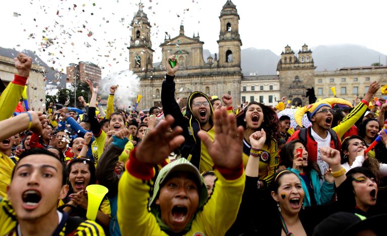 Colombia soccer fans celebrate after their team's World Cup victory over Japan in Bogota, Colombia, Tuesday, June 24, 2014. Substitute James Rodriguez scored a brilliant goal and set up two more for Jackson Martinez as Colombia beat Japan 4-1 on Tuesday to confirm top spot in Group C and eliminate the Asian champions from the World Cup. (AP Photo/Javier Galeano)
