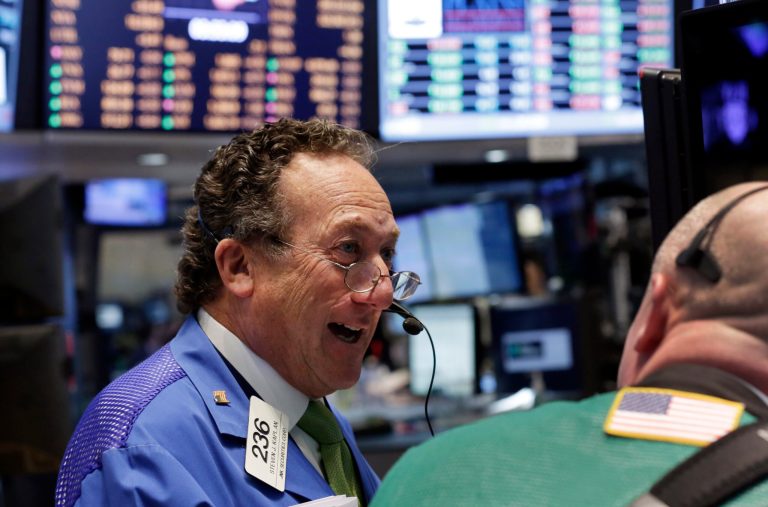 Steven Kaplan, left, shares a light moment with a fellow trader on the floor of the New York Stock Exchange, before the close of trading, Monday, April 28, 2014. Stocks turned higher late Monday afternoon as a choppy day of trading drew to a close. Indexes swung in a wide range as investors tempered their enthusiasm over a potential $100 billion pharmaceutical deal with skepticism over Internet and other formerly highflying stocks.  (AP Photo/Richard Drew)