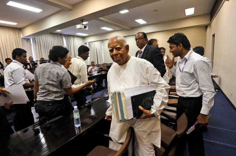   Sri Lankan opposition lawmaker Rajavarothiam Sampanthan, foreground, leaves after addressing the media at the Parliament in Colombo, Sri Lanka, Friday, Dec. 7, 2012. Sri Lankan opposition lawmakers Friday withdrew from a committee looking into impeachment charges against Chief Justice Shirani Bandaranayake, saying the process is flawed and unfair. (AP Photo/Eranga Jayawardena)  