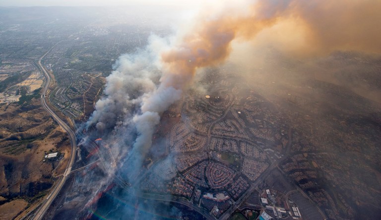 Deadly wildfires whipped by powerful winds swept through California wine country Monday, destroying 1,500 homes and businesses and sending thousands fleeing as flames raged unchecked through high-end resorts, grocery stores and tree-lined neighborhoods. (Cindy Yamanaka/The Orange County Register via AP)