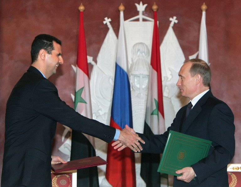   FILE - In this Jan. 25, 2005 file photo, Syrian President Bashar Assad, left, and Russian President Vladimir Putin shake hands during a signing ceremony in the Kremlin, Moscow. Russia has shielded Syrian President Bashar Assadâs regime, its last ally in the Arab world, from international sanctions and has continued to provide it with weapons despite international outrage. It has shipped billions of dollars worth of missiles, combat jets, tanks, artillery and other military gear to Syria over more than four decades. (AP Photo/Sergei Chirikov, Pool-File)  