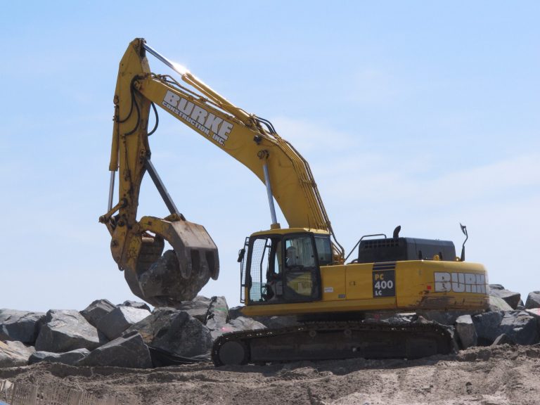In this May 12, 2014 photo, heavy equipment moves boulders into place on the Mantoloking N.J., shoreline to provide an extra layer of protection against storms like Superstorm Sandy. Experts say most of the Jersey shore's beaches came through the winter in fine shape, and are in their best condition in years as the second summer after Sandy approaches. (AP Photo/Wayne Parry)