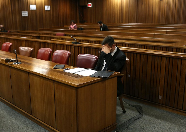 Oscar Pistorius sits in court before the fourth day of sentencing proceedings in the high court in Pretoria, South Africa, Thursday, Oct. 16, 2014. Yesterday saw the first family member, first cousin of the late Reeva Steenkamp, Kim Martin, testified at the double-amputee athlete's trial. Pistorius faces up to 15 years in prison after being convicted of culpable homicide, or negligent killing, for shooting Steenkamp, although he could also receive a suspended jail sentence and a fine. (AP Photo/Alon Skuy, Pool)