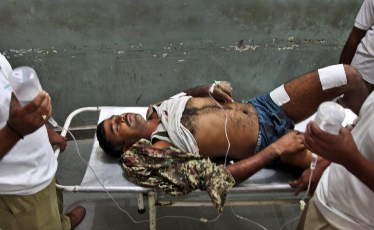An Indian Border Security Force soldier is carried on a stretcher for treatment at the Government Medical College Hospital after being injured in attacks between India-Pakistan firing at the border area in Ranbir Singh Pura, in Jammu, India, Thursday, Oct. 9, 2014. Troops trading heavy fire between Pakistan and Indian-controlled Kashmir plunged civilians on both sides into grief with many killed and wounded this week, prompting many to question how two nations committed to a 2003 cease-fire could be targeting civilians while trading blame about who started shooting first. (AP Photo/Channi Anand)