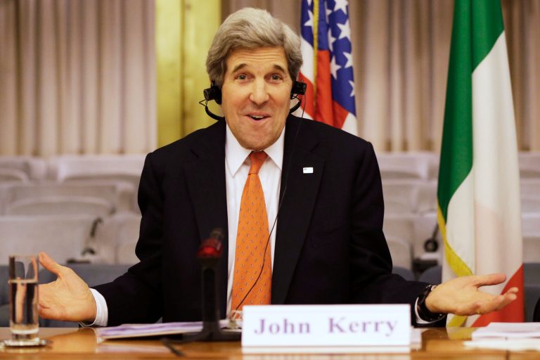 FILE - In this Feb. 28, 2013, file photo, U.S. Secretary of State John Kerry, who speaks several languages, jokes about needing headphones to listen to Italian during a cultural event with Italian Foreign Minister Terzi, not pictured, at the Ministry of Foreign Affairs in Rome. With the smile of a seasoned politician, a flair for languages and a vast repertoire of personal anecdotes, Kerry schmoozed and cajoled his way through Europe and the Middle East on his first trip abroad as America's top envoy over the past 10 days. (AP Photo/Jacquelyn Martin, Pool)