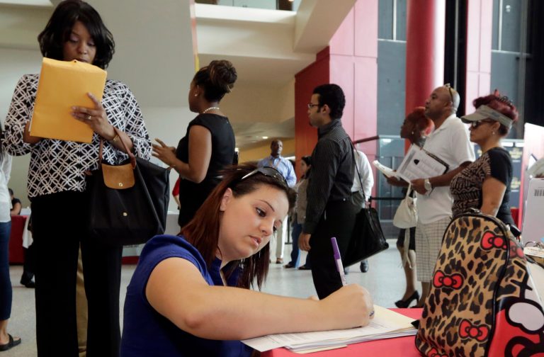 FILE - In this Aug. 19, 2014 file photo, Jessica Pimentel, of Hollywood, Fla., fills out a job application during a job fair in Sunrise. Fla. Optimism among chief executives at the largest U.S. companies fell in the July-September quarter after reaching a two-year high in the previous quarter. (AP Photo/Alan Diaz)