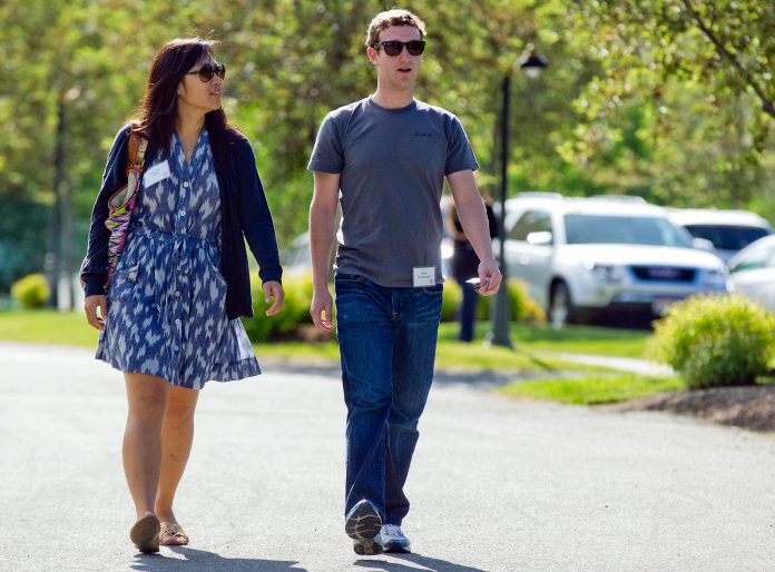 FILE- In this July 9, 2011, file photo, Mark Zuckerberg, president and CEO of Facebook, walks to morning sessions with his then girlfriend Priscilla Chan during the 2011 Allen and Co. Sun Valley Conference, in Sun Valley, Idaho.  Zuckerberg and his wife, Priscilla Chan, announced Thursday May 29, 2014 they are donating $120 million to the San Francisco Bay Area's public school system. Zuckerberg and Chan, a pediatrician, discussed the donation in an exclusive interview with the Associated Press. (AP Photo/Julie Jacobson)