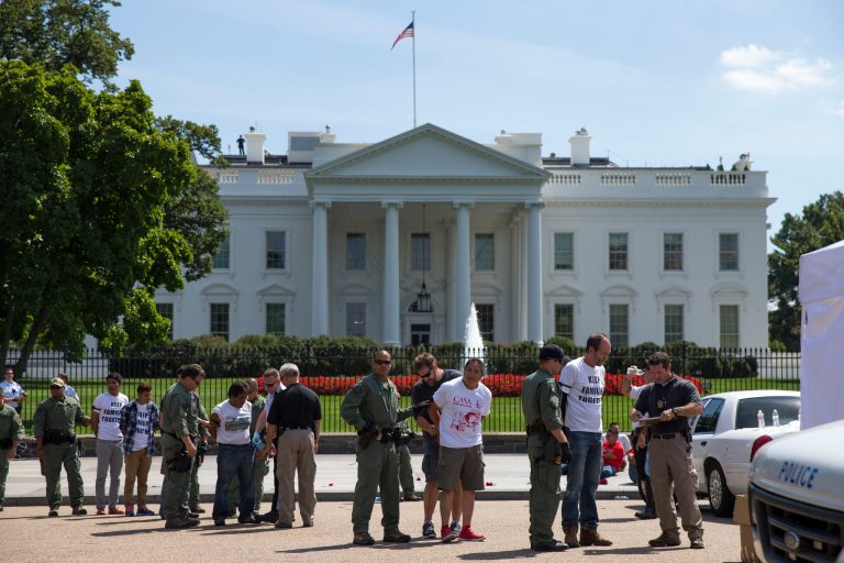 Demonstrators are lined up outside the White House in Washington, Thursday, Aug. 28, 2014, as they are being arrested during a protest on immigration reform. With impeachment threats and potential lawsuits looming, President Barack Obama knows whatever executive actions he takes on immigration will face intense opposition. So as a self-imposed, end-of-summer deadline to act approaches, Obama's lawyers are carefully crafting a legal rationale they believe will withstand scrutiny and survive any court challenges, administration officials say. (AP Photo/Evan Vucci)