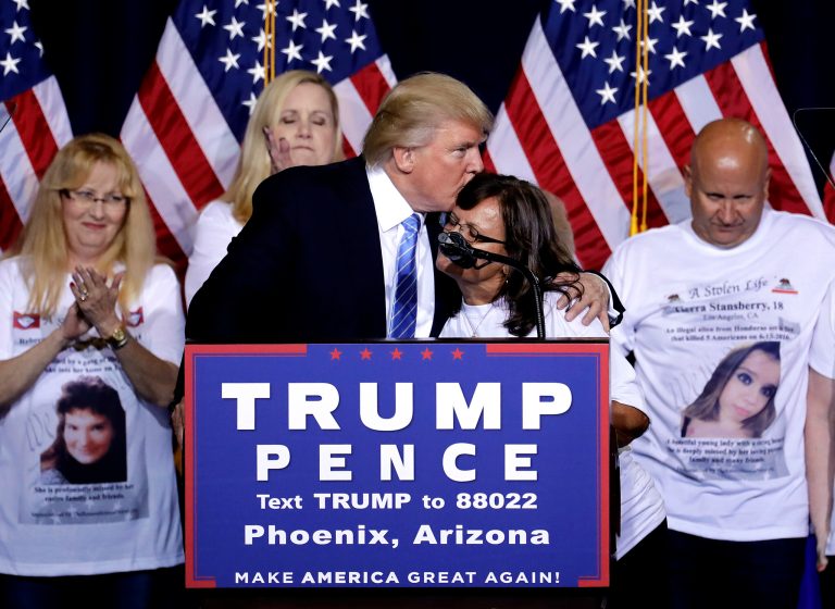 Republican presidential candidate Donald Trump hugs a woman, whose child was killed by a person living in the country without legal permission, after delivering an immigration policy speech during a campaign rally at the Phoenix Convention Center, Wednesday, Aug. 31, 2016, in Phoenix. (AP Photo/Matt York)