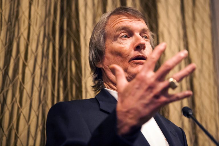 In a Wednesday, July 9, 2014 photo, UT President Bill Powers speaks during a faculty council meeting in Austin, Texas. University of Texas System regents are meeting Thursday, July 10, a day after the system announced that Powers will step down in June 2015. Powers has led the 50,000-student Austin campus since 2006. (AP Photo/The Daily Texan, Mengwen Cao)