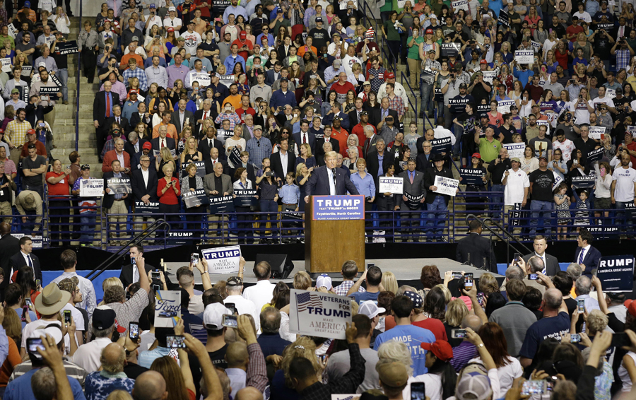 Black protester punched in face at Trump rally