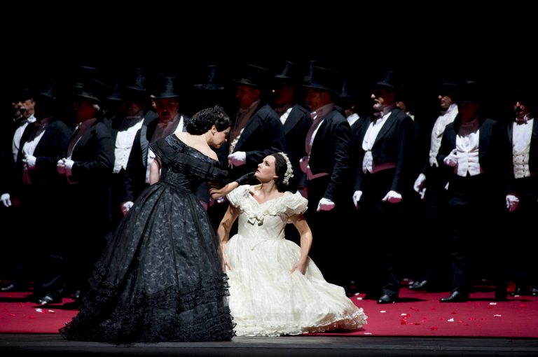   In this undated photo provided by Alla Scala theater press office, Ann Petersen, playing Elsa, right, performs during rehersals of Richard Wagner's Lohengrin at the Milan La Scala opera house, Italy. This Lohengrin is no knight in shining armor, confidently riding in on a swan to defend a beautiful maiden. No, the barefoot hero on view at La Scala these days acts more like a runaway from a home for troubled youth. He's full of odd, jerky arm movements, spends a lot of time picking swan feathers off himself, and is given to darting off stage suddenly or lying down in a fetal position when under stress. He's well-matched with the neurotic Elsa, who is easily startled and plagued by fainting spells and psychosomatic itching. Small wonder, since she's been traumatized by seeing her younger brother Gottfried kidnapped _ and, for all she knows, drowned in the Scheldt river by the sorceress Ortrud. (Actually, Ortrud turned him into a swan, which explains why Elsa is tormented by visions of him wandering across the set, one arm draped in swan feathers.) (AP Photo/Monika Rittershaus, La Scala)  