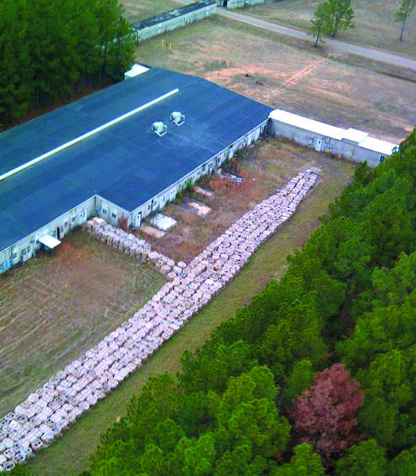 FILE - This undated file aerial photo provided by the Louisiana State Police via The Shreveport Times shows part of the smokeless explosive powder improperly stored outside Explo Systems Inc., a munitions dismantling facility at Camp Minden at Doyline, La. Explo Systems is currently under investigation for improperly storing millions of pounds of a military propellant, prompting the evacuation of the nearby town of Doyline. Documents reviewed by The Associated Press show Explo Systems Inc. was previously cited for safety violations in 2007 after old Army explosives were used in mining operations in West Virginia. (AP Photo/Louisiana State Police via The Shreveport Times)