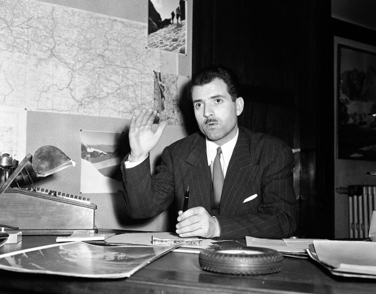   FILE - A March 11, 1950 photo from files showing Maurice Herzog, of Paris, who will lead a French mountain climbing expedition in the Himalayas this spring, talking with reporters as he describes the preparations. French mountaineer Maurice Herzog, the first person to scale the 8,091-meter (26,545-foot) Annapurna peak, has died at the age of 93. Herzog died early Friday, Dec. 14, 2012, said Pierre You, the president of the French Federation of Mountaineering and Climbing. (AP Photo/File)  