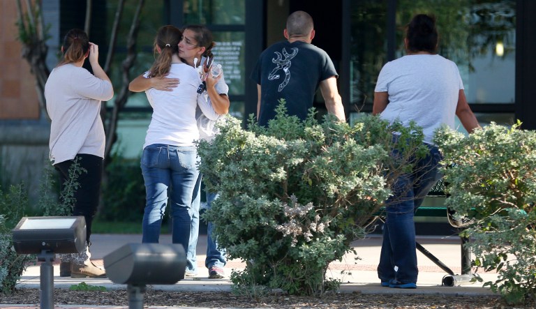 People hug outside Connally Memorial Medical Center in Floresville, Texas, Sunday, Nov. 5, 2017. A man opened fire inside of the First Baptist Church in Sutherland Springs, Texas, Sunday, killing more than 20 people. The medical center spokeswoman Megan Posey declined to say how many patients were being treated at the hospital, but said the number was less than a dozen. (William Luther/The San Antonio Express-News via AP)