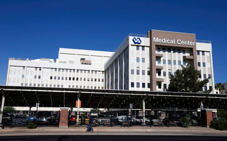 FILE - This photo taken April 28, 2014 shows the Phoenix VA Health Care Center in Phoenix. The Department of Veterans Affairs says investigators have found no proof that delays in care caused any deaths at a VA hospital in Phoenix, deflating an explosive allegation that helped expose a troubled health care system in which veterans waited months for appointments while employees falsified records to cover up the delays. (AP Photo/Ross D. Franklin, File)
