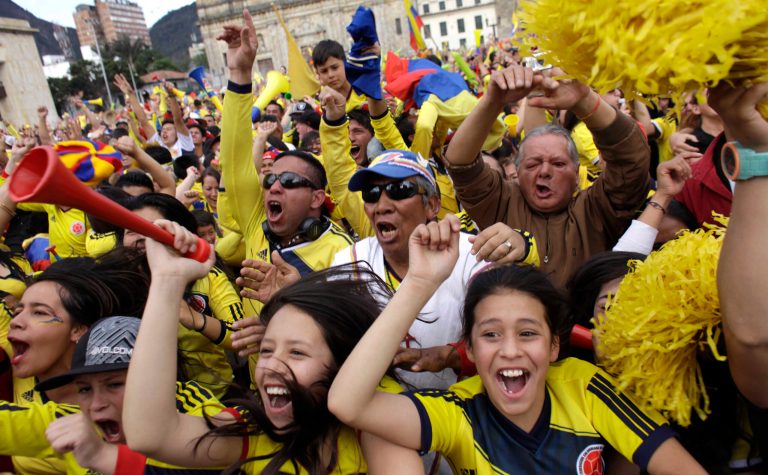 FILE - In this June 28, 2014, file photo, Colombia soccer fans celebrate a goal against Uruguay as they watch the World Cup round of 16 match on TV in Bogota, Colombia. Never before has the star-crossed nation made the quarterfinals. There is even waxing poetic about World Cup unity accelerating the pace of 18-month-old peace talks to end a half-century of conflict that has claimed some 220,000 lives. (AP Photo/Javier Galeano,File)