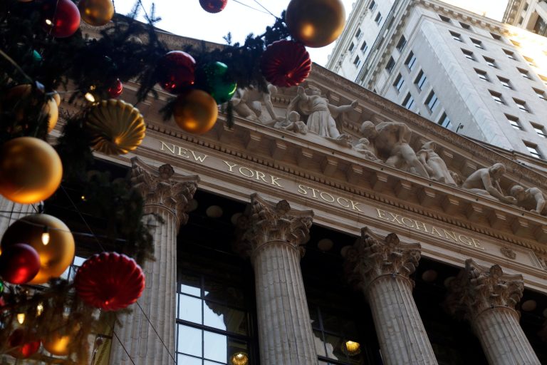   The facade of the New York Stock Exchange is framed by the NYSE holiday tree, Thursday, Dec. 20, 2012. Shares in the company that runs the New York Stock Exchange are surging amid reports that it is in talks to sell itself to a rival stock exchange, Atlanta-based IntercontinentalExchange Inc. (AP Photo/Richard Drew)  