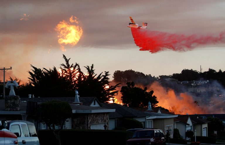 FILE - In this Sept. 9, 2010, file photo, a massive fire following a pipeline explosion roars through a mostly residential neighborhood in San Bruno, Calif. Pacific Gas & Electric Co. says it plans to appeal a $1.4 billion penalty recommended by California regulatory judges for a gas pipeline explosion in a San Francisco suburb that killed eight people. In a filing Wednesday, Sept. 3, 2014, with the U.S. Securities and Exchange Commission, the utility indicated its plan to file an appeal with the California Public Utilities Commission within 30 days. (AP Photo/Jeff Chiu, File)