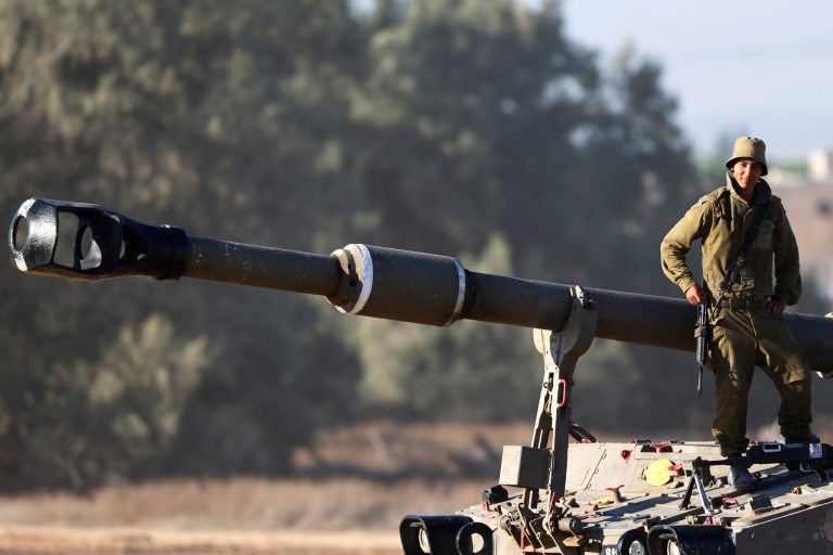 An Israeli soldier leans on the barrel of the gun of a mobile artillery unit at a position on the Israel-Gaza border, Friday, July 11, 2014. Gaza rocket fire struck a gas station and set it ablaze Friday in southern Israel, seriously wounding one person as rocket fire also came from Lebanon for the first time in the four-day-long offensive. Rocket fire by Palestinian militants continued from Gaza toward various locations in southern Israel. (AP Photo/Lefteris Pitarakis)