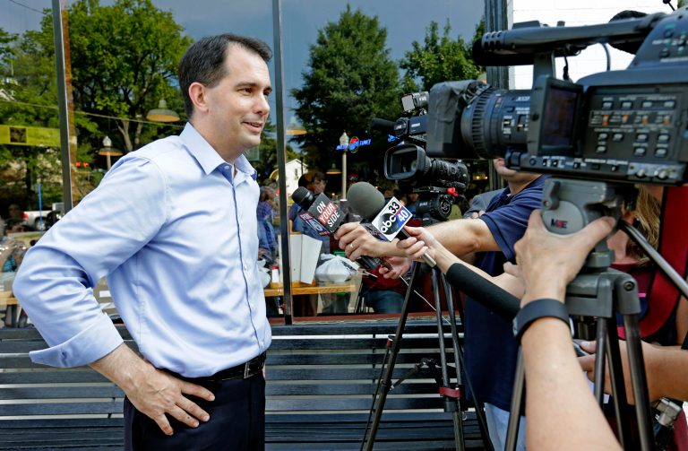 Republican presidential candidate Wisconsin Gov. Scott Walker speaks with media outside of Dreamland BBQ during a campaign stop, Saturday, Aug. 22, 2015, in Birmingham, Ala. (AP Photo/Butch Dill)