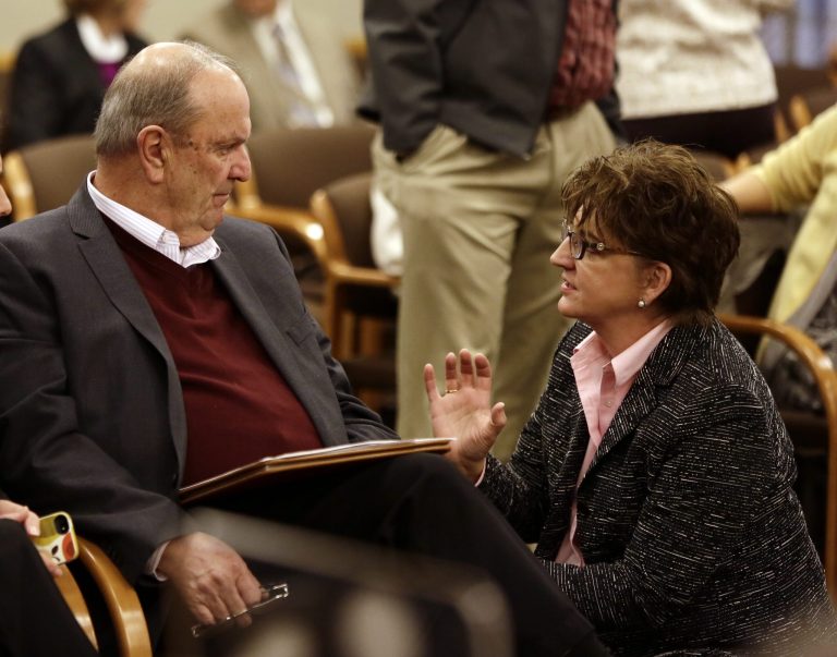 Cover Oregon executive director Rocky King, left, confers with Oregon Health Authority chief information officer Carolyn Lawson before appearing at a Joint Interim Committee on Legislative Audits, Information Management and Technology in Salem, Ore., Wednesday, Nov. 20, 2013.  The committee had questions about Oregon's troubled health insurance exchange, which still hasn't launched its online enrollment system and severely lags other states in signing people up for health care under the new federal health law.(AP Photo/Don Ryan)