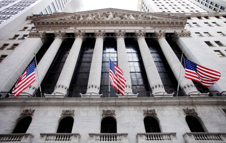 FILE - In this Feb. 10, 2011 file photo, American flags fly in front of the New York Stock Exchange, in New York. Stock futures edged higher Tuesday, July 15, 2014, as investors digested mixed U.S. retail sales data and several corporate earnings reports. The latest earnings from Johnson & Johnson and JPMorgan Chase both beat Wall Street's expectations. (AP Photo/Mark Lennihan, File)